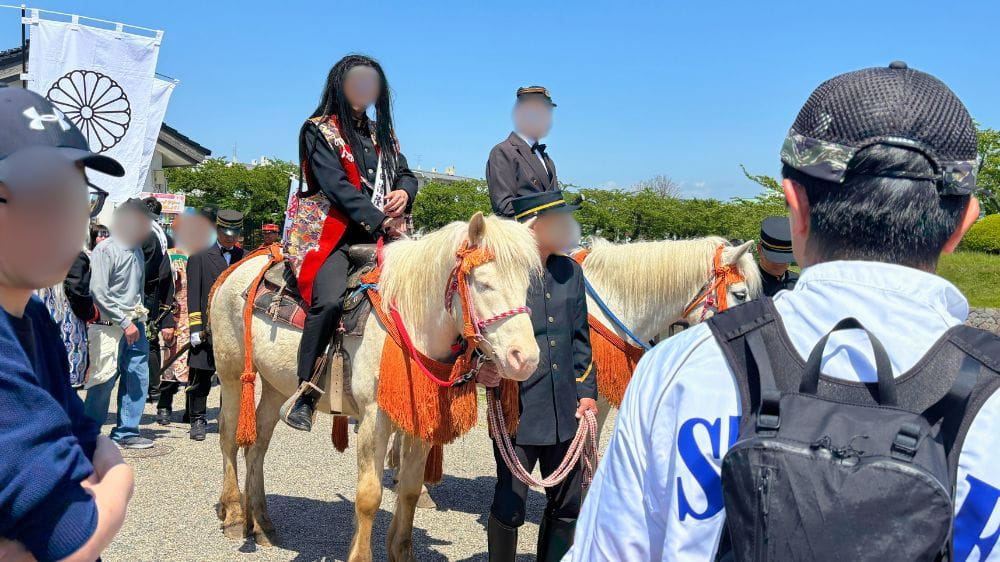 維新行列に参加する騎馬隊と見物客